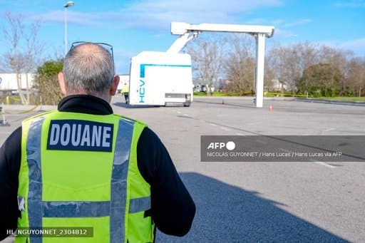 Un agent des douanes françaises devant un scanner mobile de conteneurs
